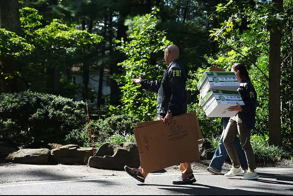 FBI agents were seen with cardboard boxes outside former Trump security adviser John Bolton's house. Credit: Getty