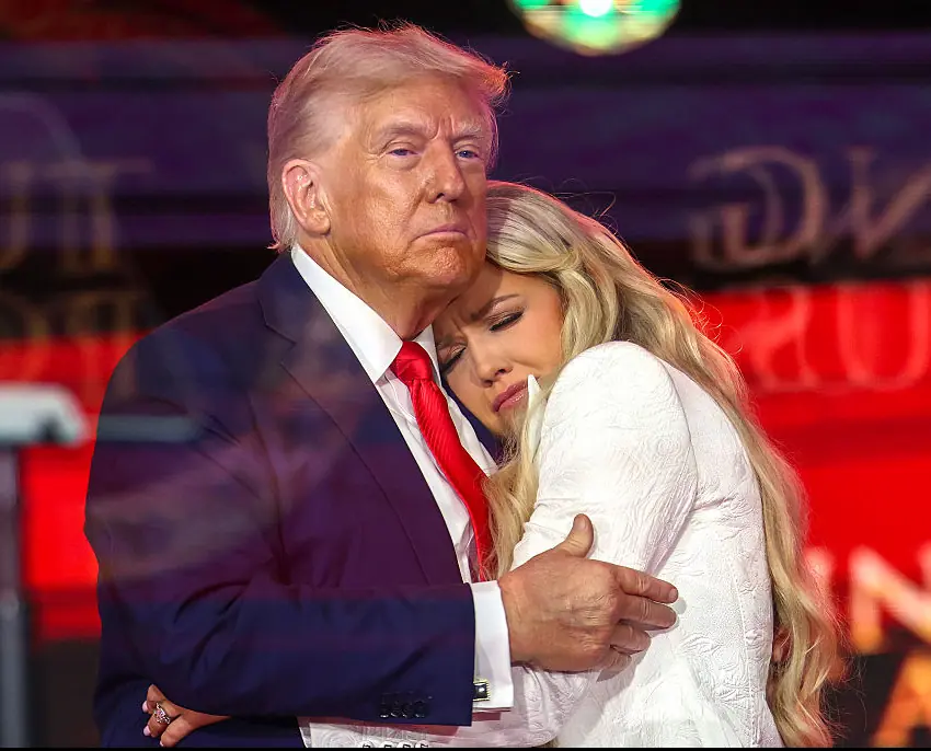 Erika Kirk and Donald Trump hugging onstage during the memorial service for Charlie Kirk. Credit: Win McNamee / Getty