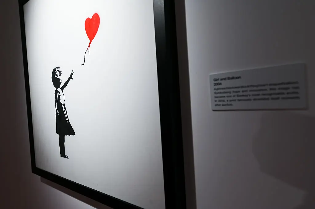 Girl with Balloon is a famous 2002 street art series by Banksy, Credit: Joe Maher / Getty
