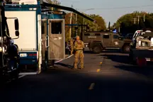 BURTON, MICHIGAN - SEPTEMBER 28: Michigan State Police and Michigan State Bomb Squad work outside a shooting suspect