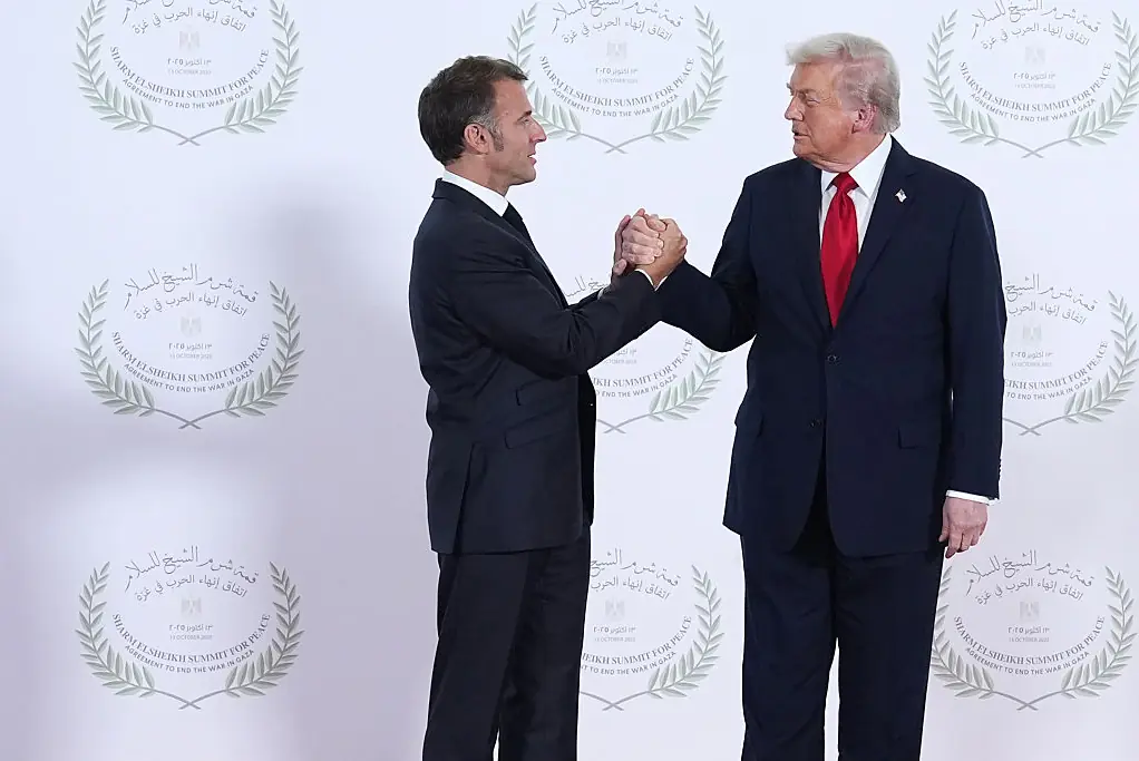 President Donald Trump greets French President Emmanuel Macron. Credit: Pool / Getty