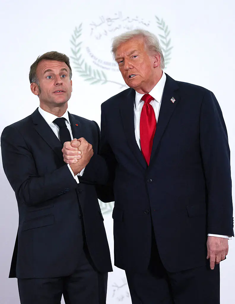 President Donald Trump and French President Emmanuel Macron pose for a photo during a world leaders' summit. Credit: Pool/Getty