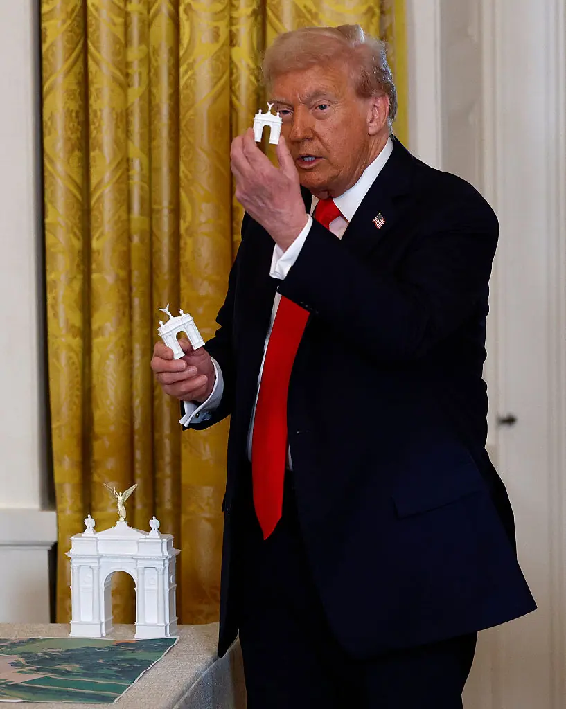 Donald Trump holds models of his Arc de Trump. Credit: Kevin Dietsch / Getty