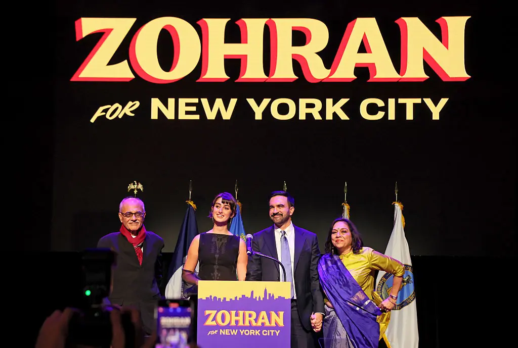 NYC Democratic mayoral candidate Zohran Mamdani stands with his wife Rama Duwaji alongside his parents Mahmood Mamdani and Mira Nair after delivering remarks at his election night watch party. Credit: Michael M. Santiago / Getty