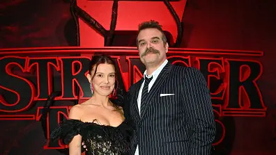 HOLLYWOOD, CALIFORNIA - NOVEMBER 06: (L-R) Millie Bobby Brown and David Harbour attend Netflix's "Stranger Things" Season 5 World Premiere at TCL Chinese 6 Theatres on November 06, 2025 in Hollywood, California. (Photo by Jerod Harris/Getty Images for Netflix)