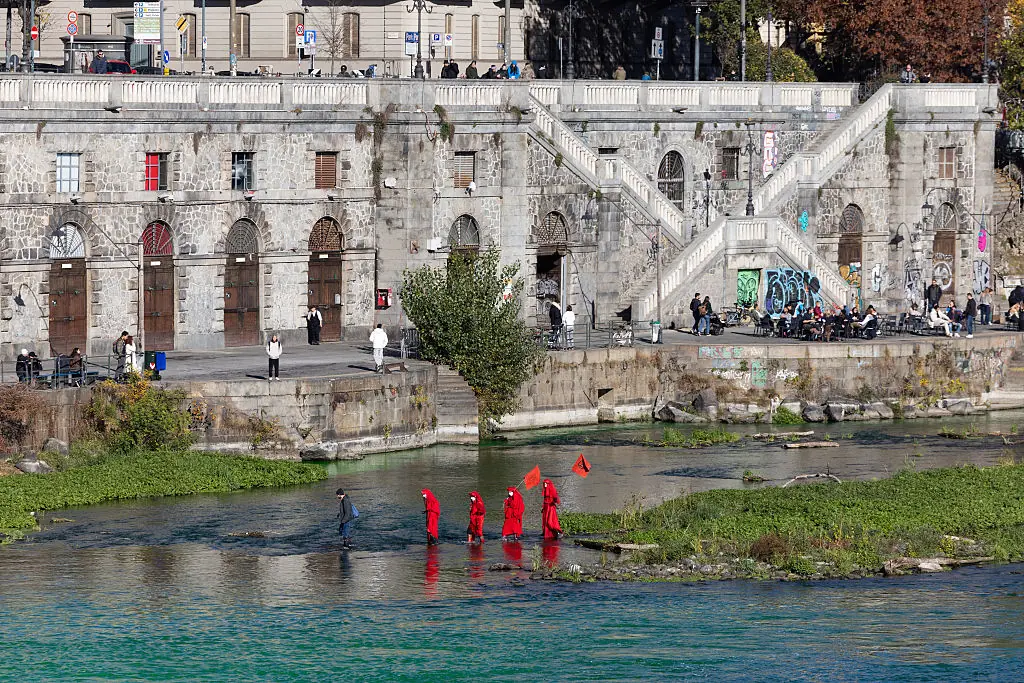 Extinction Rebellion members were seen amid the water which had been dyed green. Credit: Mauro Ujetto/NurPhoto via Getty Images
