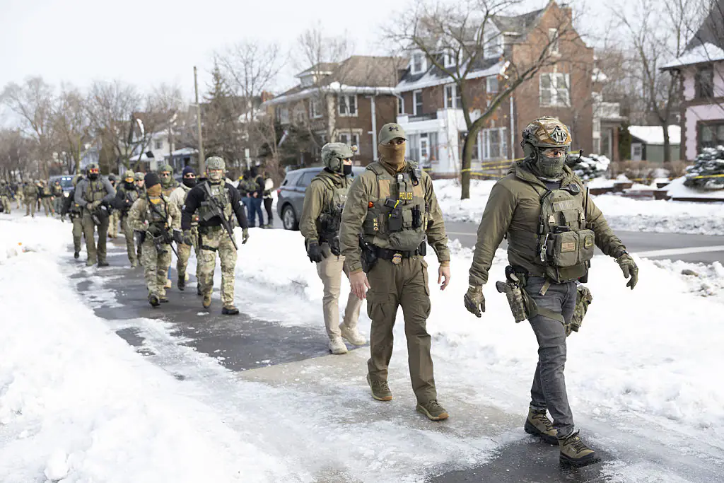 ICE agents standing at the scene where ICE agents fatally shoot a woman. Credit: Anadolu / Getty