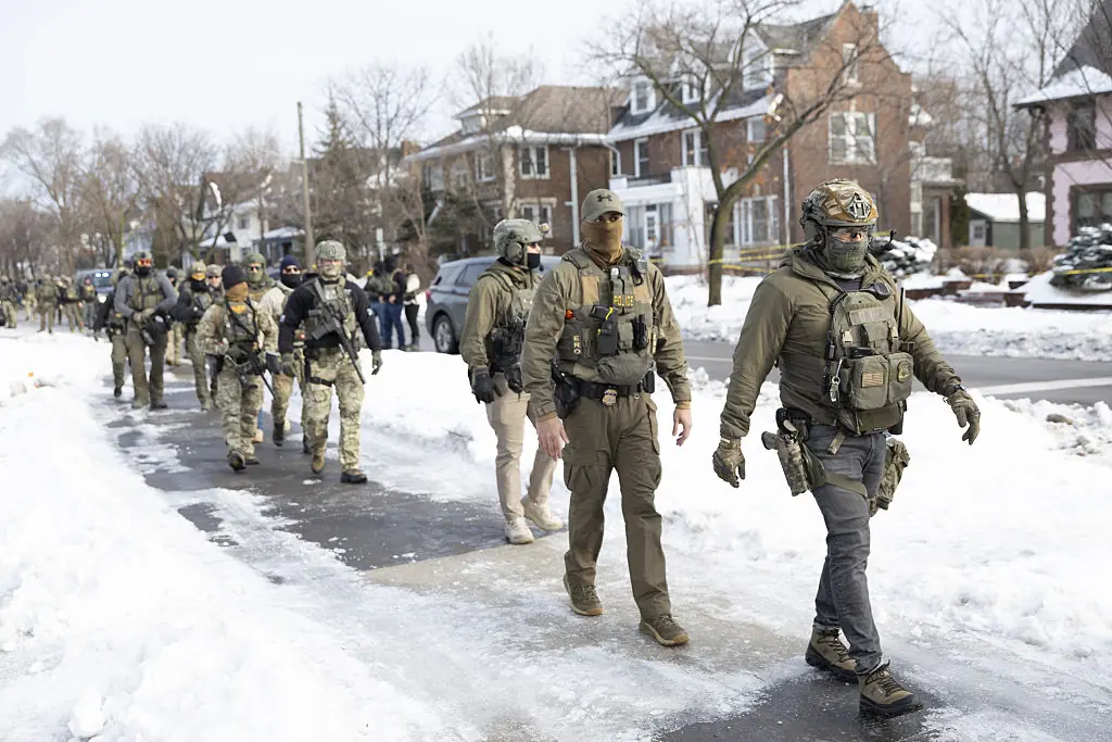 ICE agents standing at the scene where ICE agents fatally shoot a woman. Credit: Anadolu / Getty