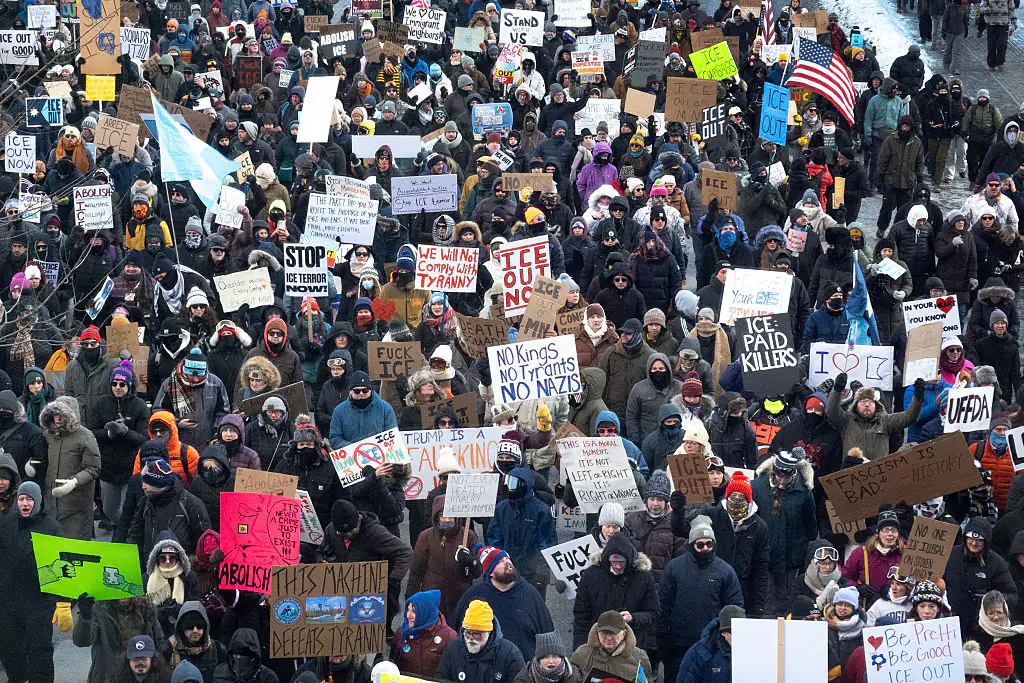 Demonstrators march through downtown protesting ICE operations and the deaths of Renee Good and Alex Pretti. Credit: Scott Olson / Getty