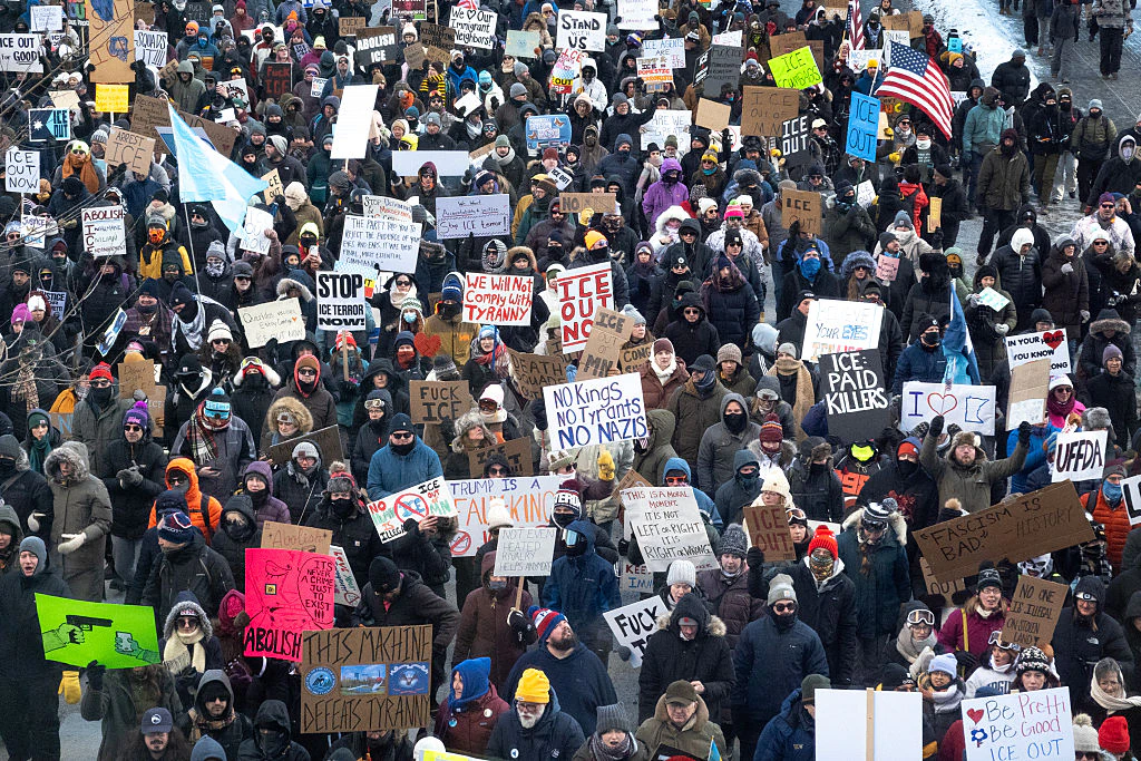 Demonstrators march through downtown protesting ICE operations and the deaths of Renee Good and Alex Pretti. Credit: Scott Olson / Getty