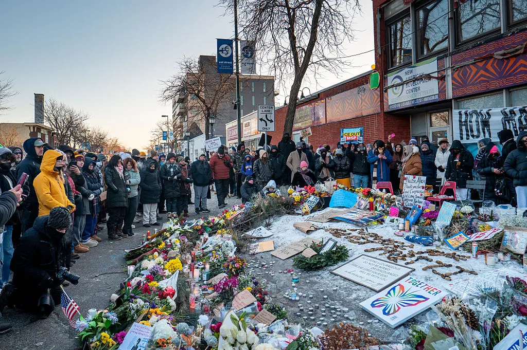 People pay their respects at a memorial site for Alex Pretti on January 25. Credit:	Brandon Bell / Getty