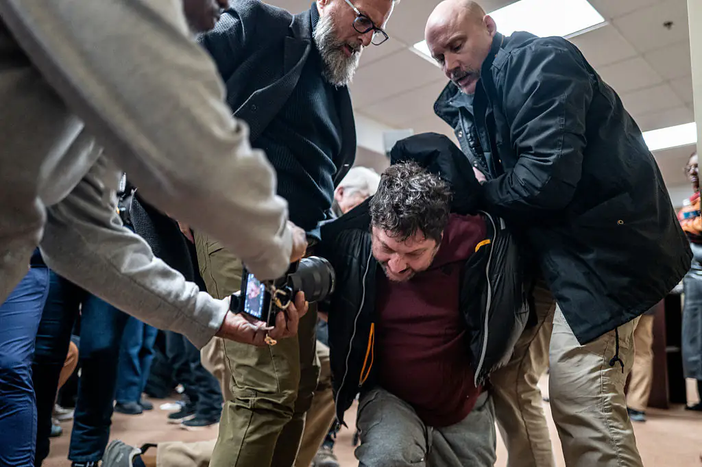 A person is tackled after attempting to attack Rep. Ilhan Omar. Credit: Brandon Bell / Getty