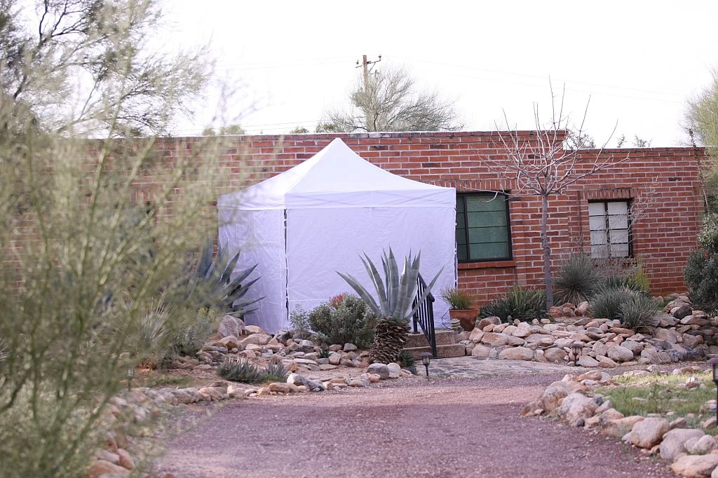 Police put a white tent outside of Nancy Guthrie's residence. Credit: 	Anadolu / Getty