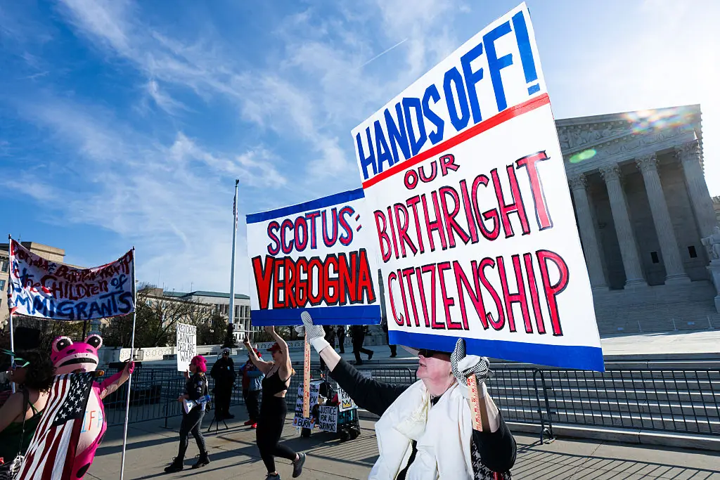 Protesters hold signs supporting birthright citizenship outside the Supreme Court on April 1. Credit: Bill Clark / Getty