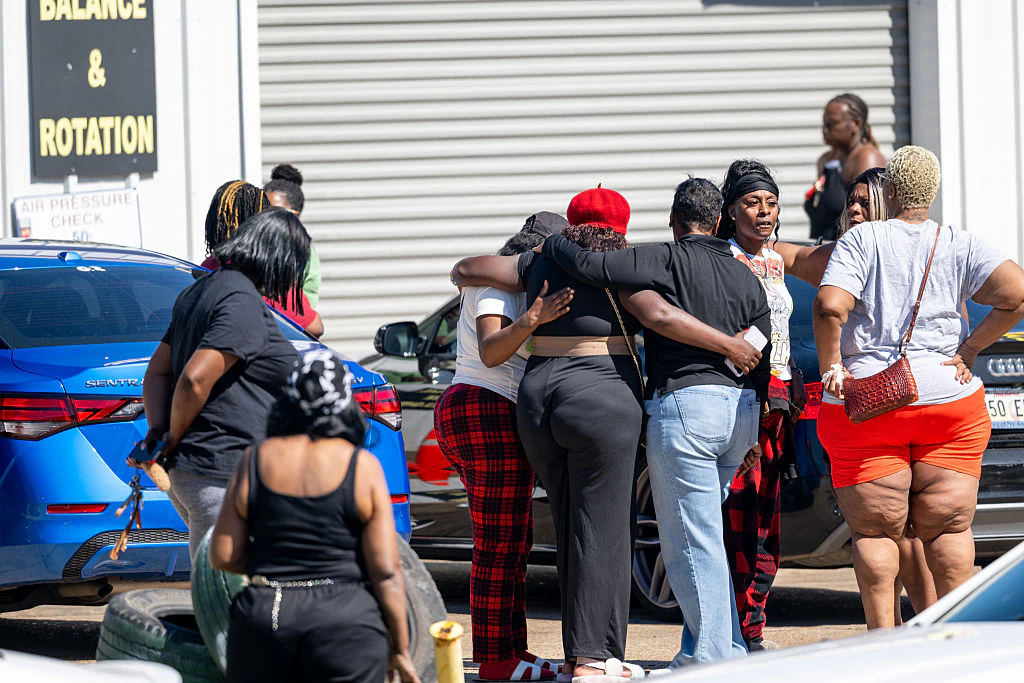 Community members gather to grieve the death of eight children and two women during a mass shooting on April 19. Credit: Brandon Bell / Getty