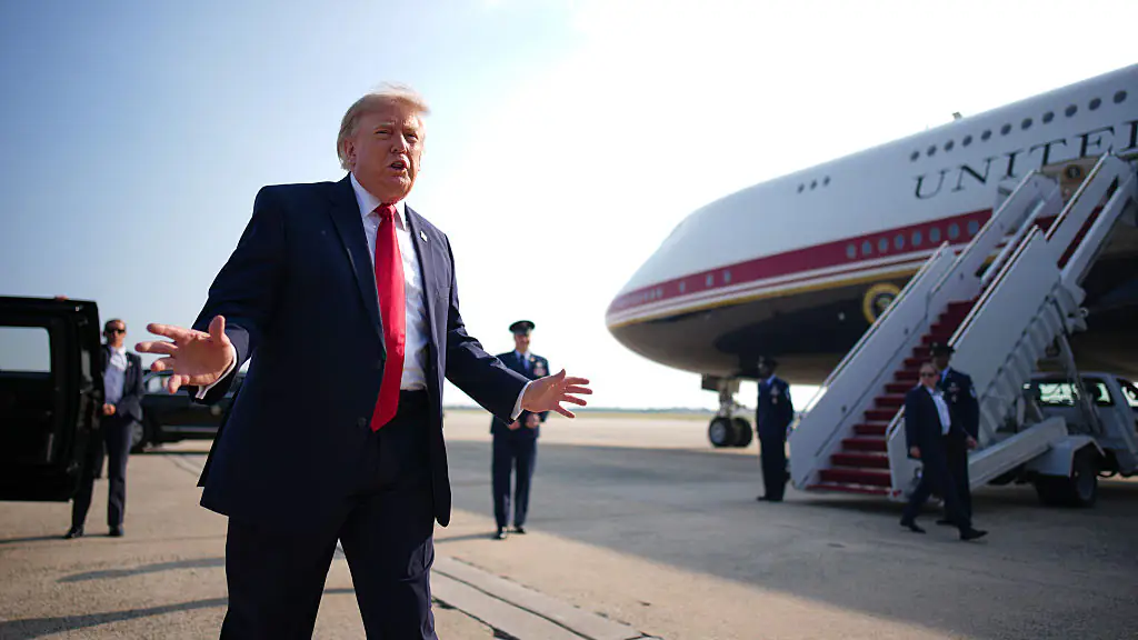 Trump is clearly very happy with his present. Credit: Andrew Harnik/Getty