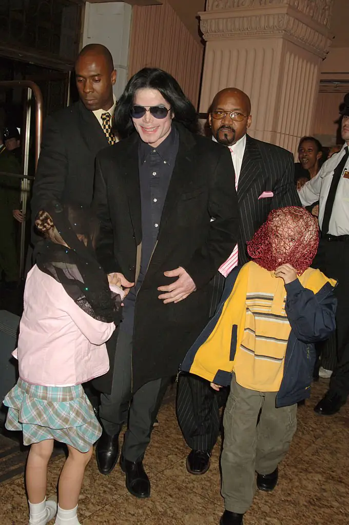 Michael Jackson with Prince and Paris, both with their faces covered by scarves. Credit: Dave M. Benett/Getty Images