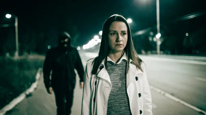 Man following woman at night