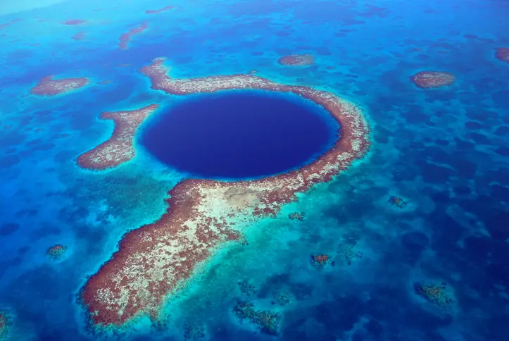 The Great Blue Hole is located off the coast of Belize in Central America. Credit: Andrew Hounslea / Getty