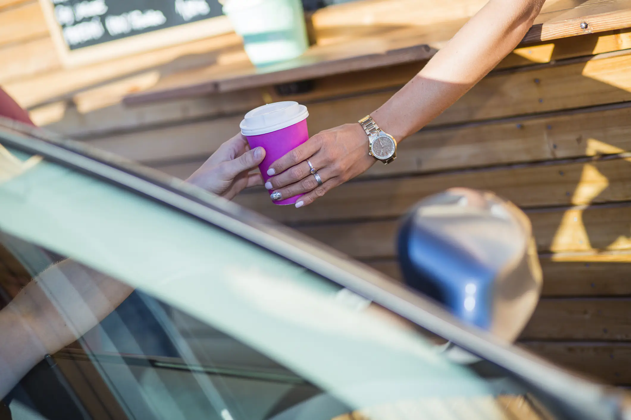 Bikini-wearing barista smashes customer's windscreen with a hammer after he threw his coffee at her