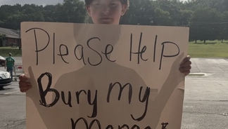 11-year-old boy leaves motorists heartbroken after standing at roadside with sign reading: 'Please help bury my mama'