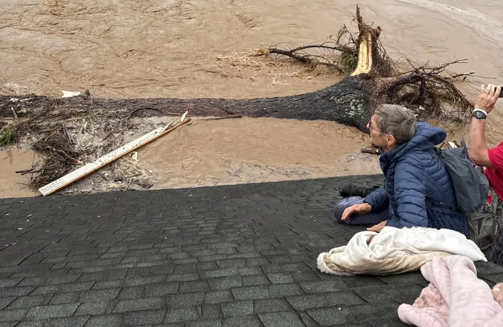 Tragic final photo shows grandparents stranded on rooftop before being swept away with 7-year-old grandson