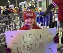 Drunk fans push girl, 8, holding 'I beat cancer' sign down stairs at her first NFL game, mom claims