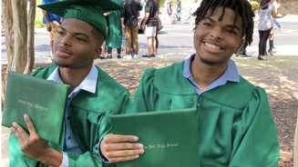 Firefighter charged after allegedly sharing images of twin brothers who died of gunshot wounds on mountain