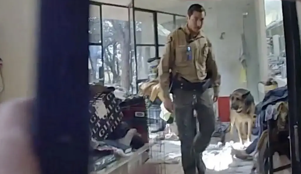 Bodycam footage shows a dog found guarding the body. Credit: Santa Fe Sheriff's Office