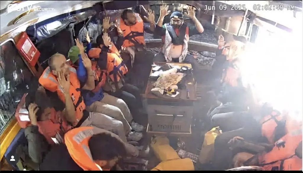 The 12 on board were seen with their hands in the air in the last image released from the Madleen. Credit: Freedom Flotilla Coalition/Instagram