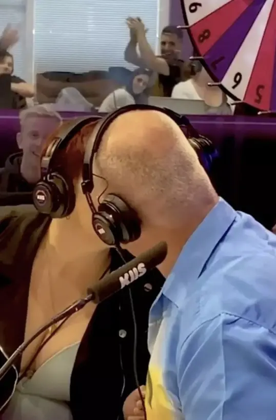 The father and daughter shared a kiss to win the money. Credit: KIIS1065 / Instagram