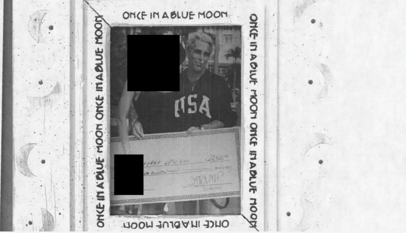 Epstein holding a cheque signed by D. Trump. Credit: US Department of Justice