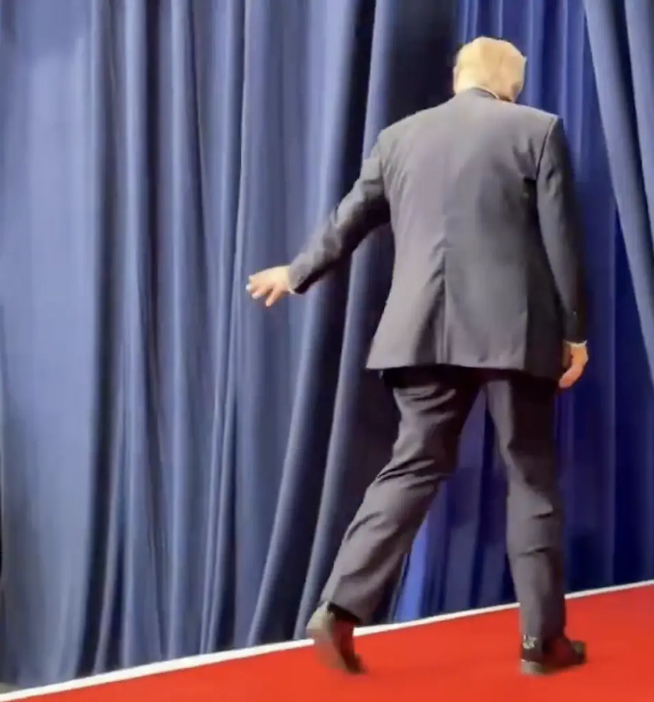 Trump was seen flicking his hand towards the staffers off-stage, who responded. Credit: X