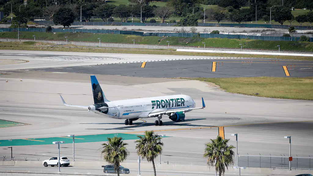 Horror as Frontier Airlines flight with 231 people on board fatally hits person on runway as he's 'sucked into engine'