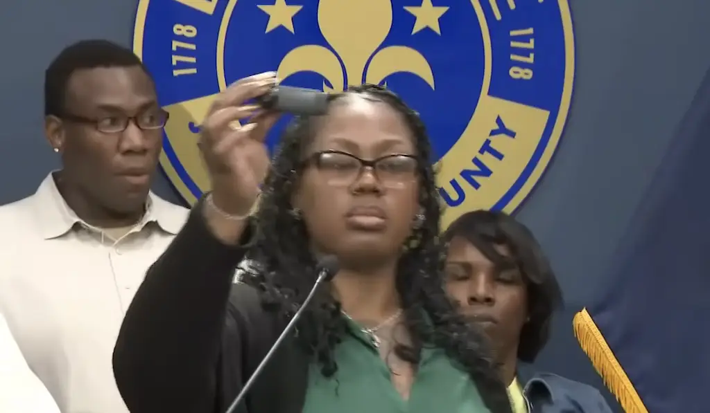 Tiphanee Lee holding the camera she put in her autistic son's hair during a press conference. Credit: WLKY News Louisville