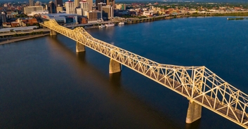 Woman left hanging from bridge 75ft over river after terrifying crash, footage shows