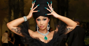 Cardi B 'shuts down the Met Gala red carpet' as she requires nine men to help move her dress