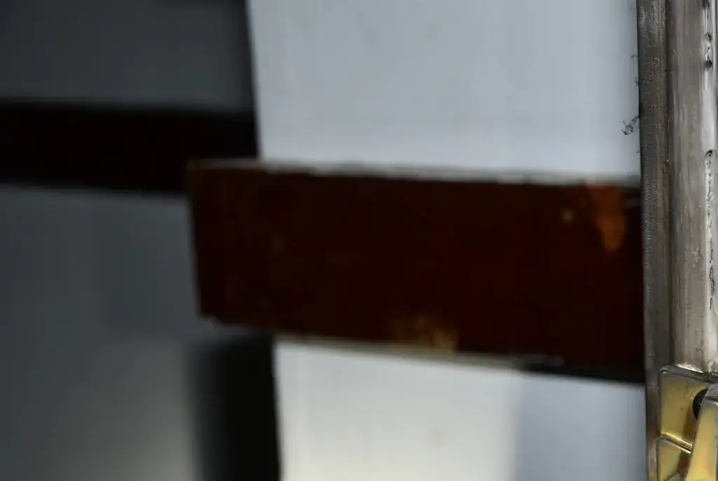 The photos show several doors of the home, including one with a lock that appears to have been hastily reinforced with painted plywood. Credit:  Waterbury Police Department