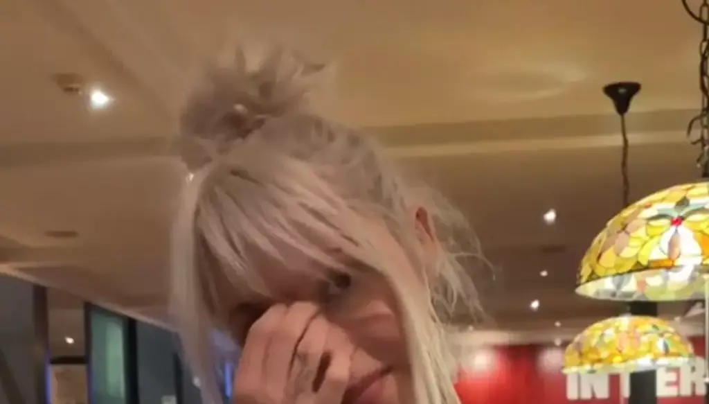 Man awkwardly mocks woman wearing band t-shirt without having a clue who she is