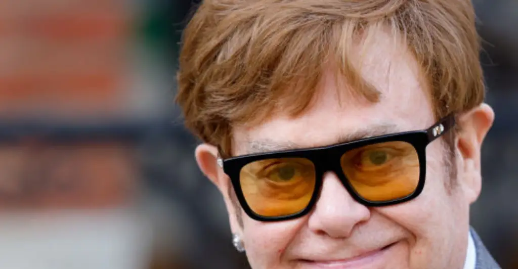Elton John reveals he has 'lost his eyesight' as he's helped off the stage by his husband David Furnish