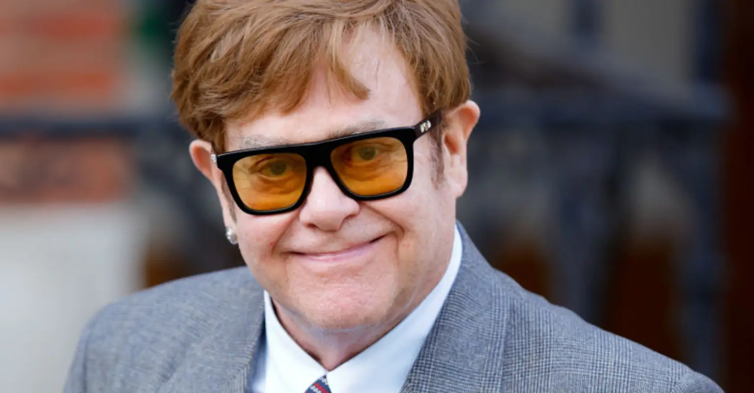 Elton John reveals he has 'lost his eyesight' as he's helped off the stage by his husband David Furnish