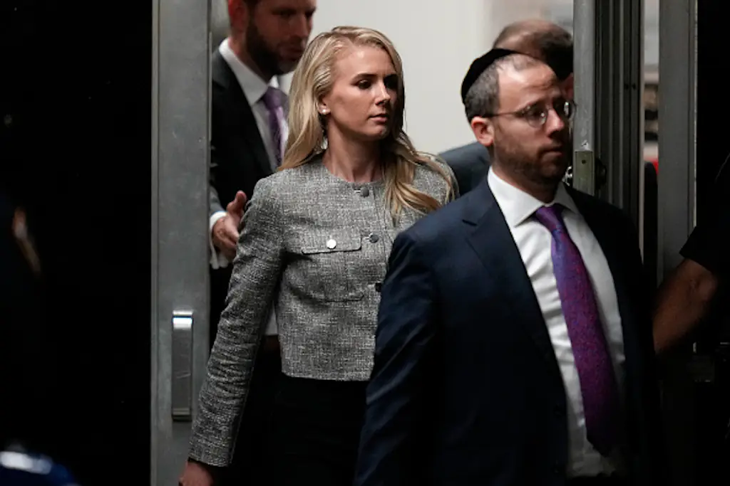 Questions have been raised over who Natalie Harp is after she was spotted carrying a bag for Donald Trump. Credit:  Julia Nikhinson-Pool/Getty Images