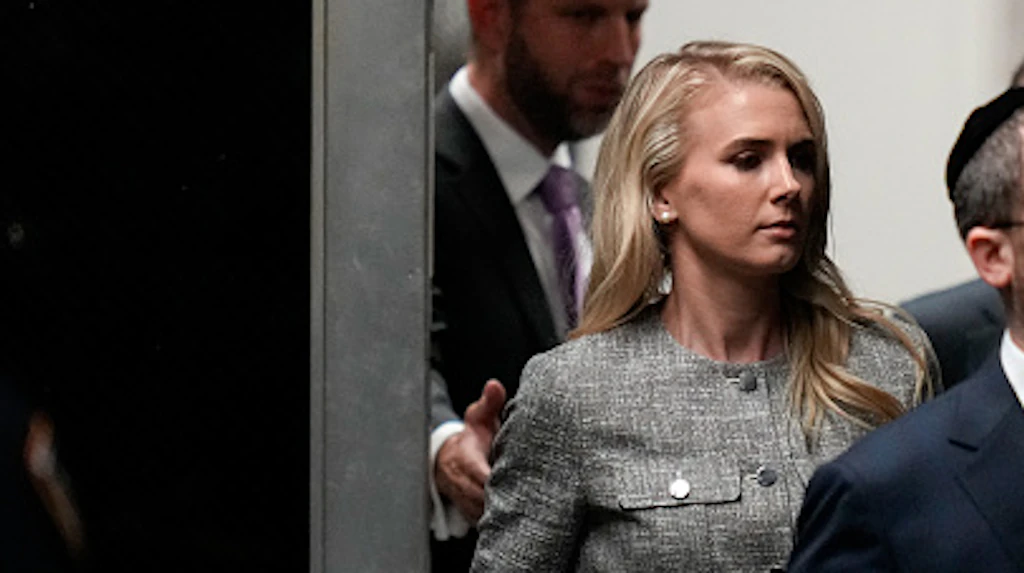 Who is the 'mystery woman' with a large red bag spotted following Donald Trump around? Several theories have emerged