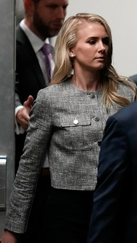 Questions have been raised over who Natalie Harp is after she was spotted carrying a bag for Donald Trump. Credit:  Julia Nikhinson-Pool/Getty Images