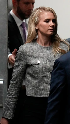 Questions have been raised over who Natalie Harp is after she was spotted carrying a bag for Donald Trump. Credit:  Julia Nikhinson-Pool/Getty Images