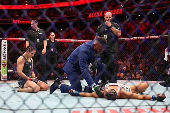 Alexa Grasso celebrates victory as Maycee Barber remains unconscious. Credit: Mat Hayward/Getty Images
