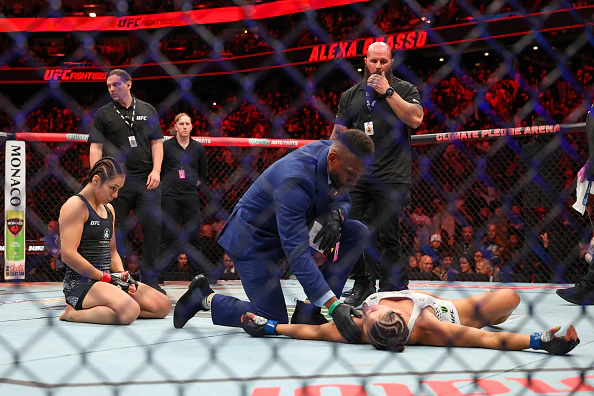 Alexa Grasso celebrates victory as Maycee Barber remains unconscious. Credit: Mat Hayward/Getty Images