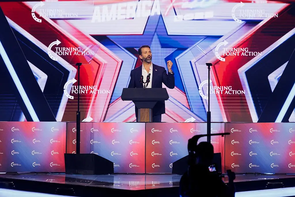The president playfully threatened to fire his son, Donald Trump, at the TPUSA event. Credit: Caylo Seals / Getty 