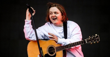 Lewis Capaldi poses alongside statue of himself gifted to him by his former school