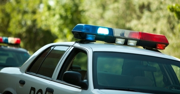 Police launch investigation as cop is caught kissing woman and joining her in backseat of cruiser